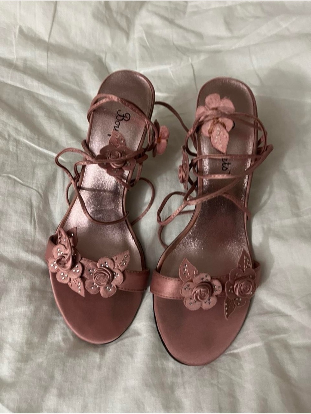 Vintage pink heels with flower embellishments and lace-up straps